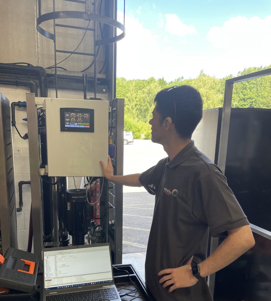 Engineer with a PLC control panel